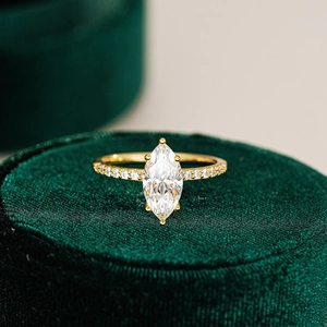 Classic marquise-cut moissanite ring in gold finish with pavé set band on velvet box