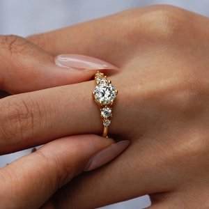 Luxurious S925 sterling silver gold ring with round moissanite on a female hand