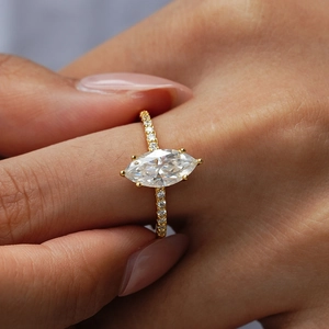 Classic marquise-cut moissanite ring in gold finish with pavé-set diamonds on the band