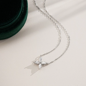 Detail view of S925 sterling silver four-leaf clover necklace with sparkling moissanite stones