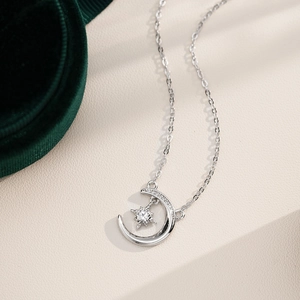 Elegant S925 sterling silver moon and star necklace with moissanite on green velvet