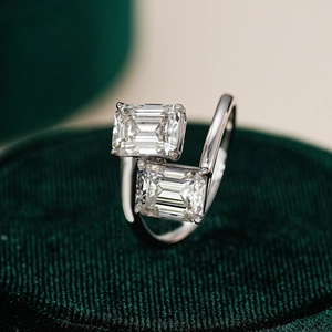 Toi et Moi silver ring with dual emerald cut moissanite stones on velvet base