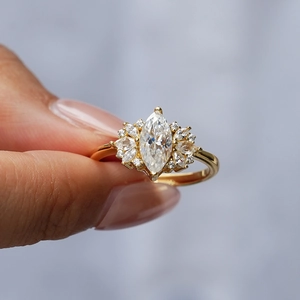 Elegant gold S925 silver ring with marquise-cut moissanite stone in sunburst pattern