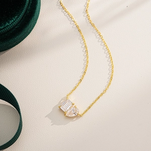 Detailed close-up of 18K gold-plated S925 silver necklace with emerald and teardrop crystals