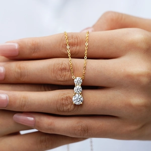 Elegant 2 carat moissanite three-stone pendant necklace in brilliant gold finish