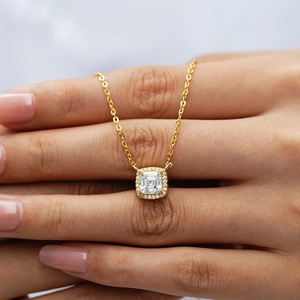 Elegant gold necklace with a square-cut moissanite pendant shown on a hand