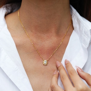 Elegant 925 sterling silver oval moissanite pendant necklace worn on a classic white shirt