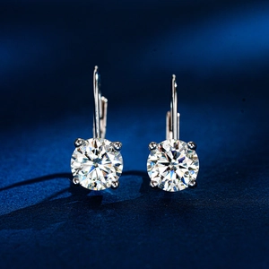 Macro detail of 925 sterling silver four-prong moissanite leverback drop earrings