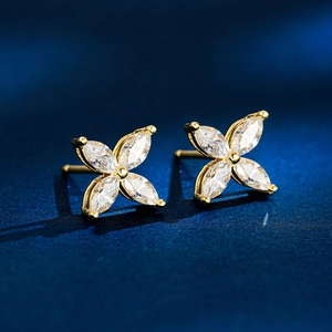 Macro shot of 925 silver clover studs with marquise-cut stones and gold plating