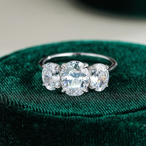 Macro shot of three oval-cut moissanite stones on a S925 sterling silver ring band