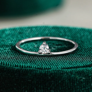 Macro shot of S925 sterling silver ring with brilliant round moissanite in a velvet box