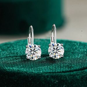 Macro detail of round cut moissanite earrings with 925 silver leverback classic four-prong setting