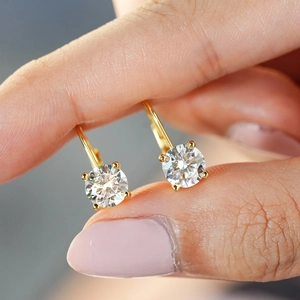 Classic 925 sterling silver four-prong moissanite leverback earrings shown on fingers
