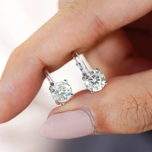 Classic 925 sterling silver four-prong moissanite drop earrings shown on fingers