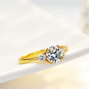 Elegant 1 carat round moissanite three-stone ring in 14K gold plated silver