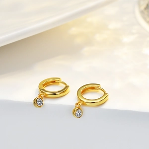 Polished 14K gold plated silver hoop earrings with round cut zircon drop on white steps