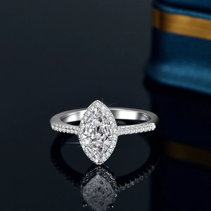 Marquise cut moissanite halo ring in 925 sterling silver with pavé band on black mirror