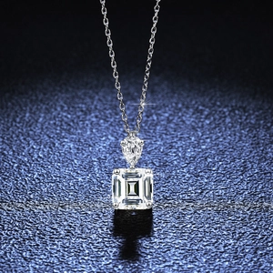 S925 sterling silver necklace with pear and emerald cut moissanite stones on blue background