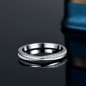 Elegant s925 silver wave ring with cross moissanite diamonds on a reflective surface