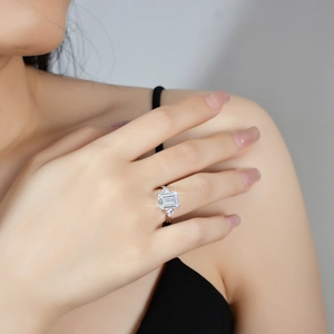 Luxurious 4-carat emerald cut moissanite ring in S925 silver on female model hand