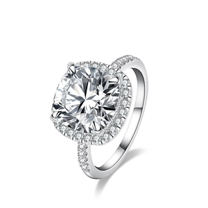 Close-up of a 5 carat radiant cut moissanite ring with a silver halo setting