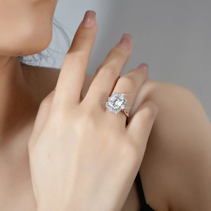 Luxurious S925 silver emerald-cut moissanite ring worn by a model in soft lighting