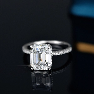 S925 sterling silver ring with a 4-carat emerald cut moissanite on a black background