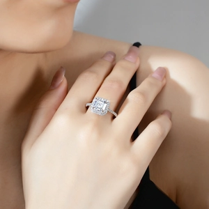 Emerald cut moissanite halo ring in S925 sterling silver worn on a finger
