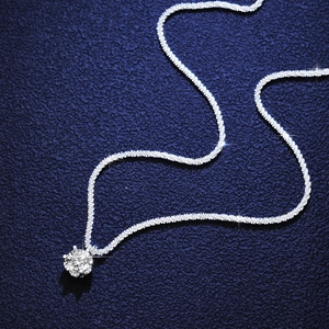 Elegant S925 silver necklace with sparkling round moissanite pendant on blue background