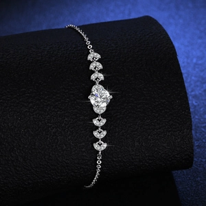 Elegant 925 sterling silver bracelet with round moissanite and heart accents on black stand