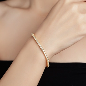 Elegance 2.5mm Moissanite tennis bracelet in D color with high-polished gold finish on wrist