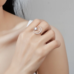 Elegant silver moon and star open ring with sparkling pavé moissanite on female finger