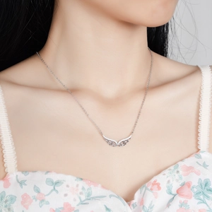 Elegant S925 sterling silver angel wing necklace with sparkling moissanite on a model