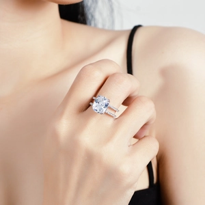 S925 silver cushion cut moissanite ring with a double row diamond band on a model hand