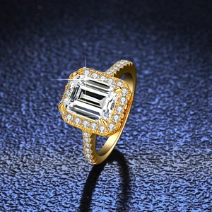 Luxury 3-carat emerald cut moissanite ring with halo setting on a gold pavé band