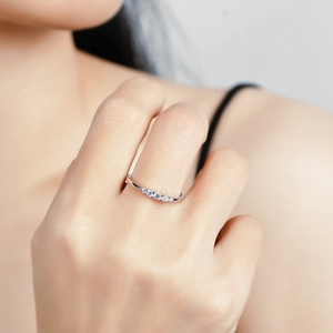 Minimalist S925 silver ring with five sparkling round moissanite stones on female finger