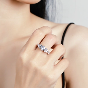 925 sterling silver ring with princess cut moissanite stone on a finger
