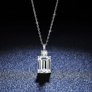 S925 sterling silver emerald-cut moissanite pendant necklace on textured blue background