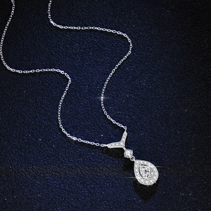 Elegant S925 sterling silver necklace with pear-cut moissanite pendant on a blue background