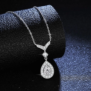 Elegant S925 sterling silver necklace with teardrop moissanite pendant on black base