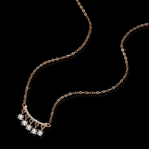 Elegant rose gold S925 silver necklace with five dangling moissanite stones on black mirror