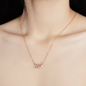S925 silver fringe necklace with moissanite bells in rose gold finish on a model