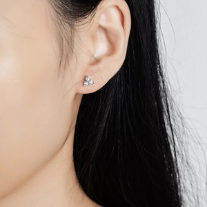 Elegant S925 silver clover stud earrings with three round moissanite stones on model