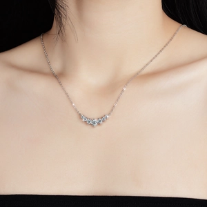 Close-up of S925 sterling silver V-shaped necklace with five brilliant moissanite stones