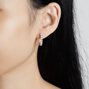 Elegant gold plated s925 silver hoop earrings with sparkling moissanite on female model