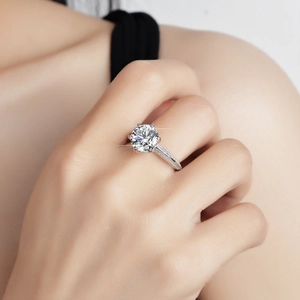 Close-up of sparkling 3-carat moissanite ring with six-prong setting on a model hand