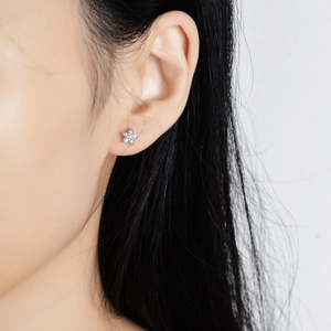 Elegant S925 silver flower stud earrings with sparkling moissanite stones on female model