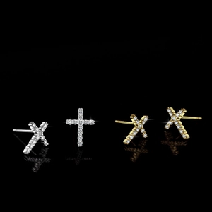 Sparkling S925 silver and gold cross stud earrings with moissanite stones on black background