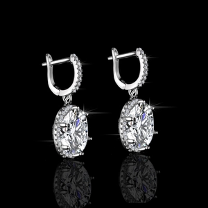 Elegant S925 silver hoop earrings with a large oval moissanite pendant on black background