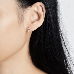 Elegant s925 silver cross stud earrings with sparkling moissanite on a female model